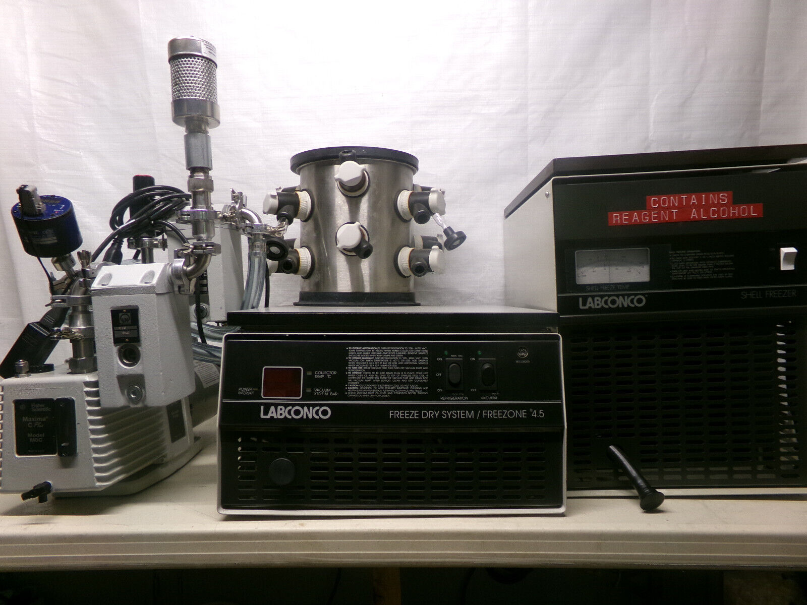 Freeze dryer and vacuum pump on table.