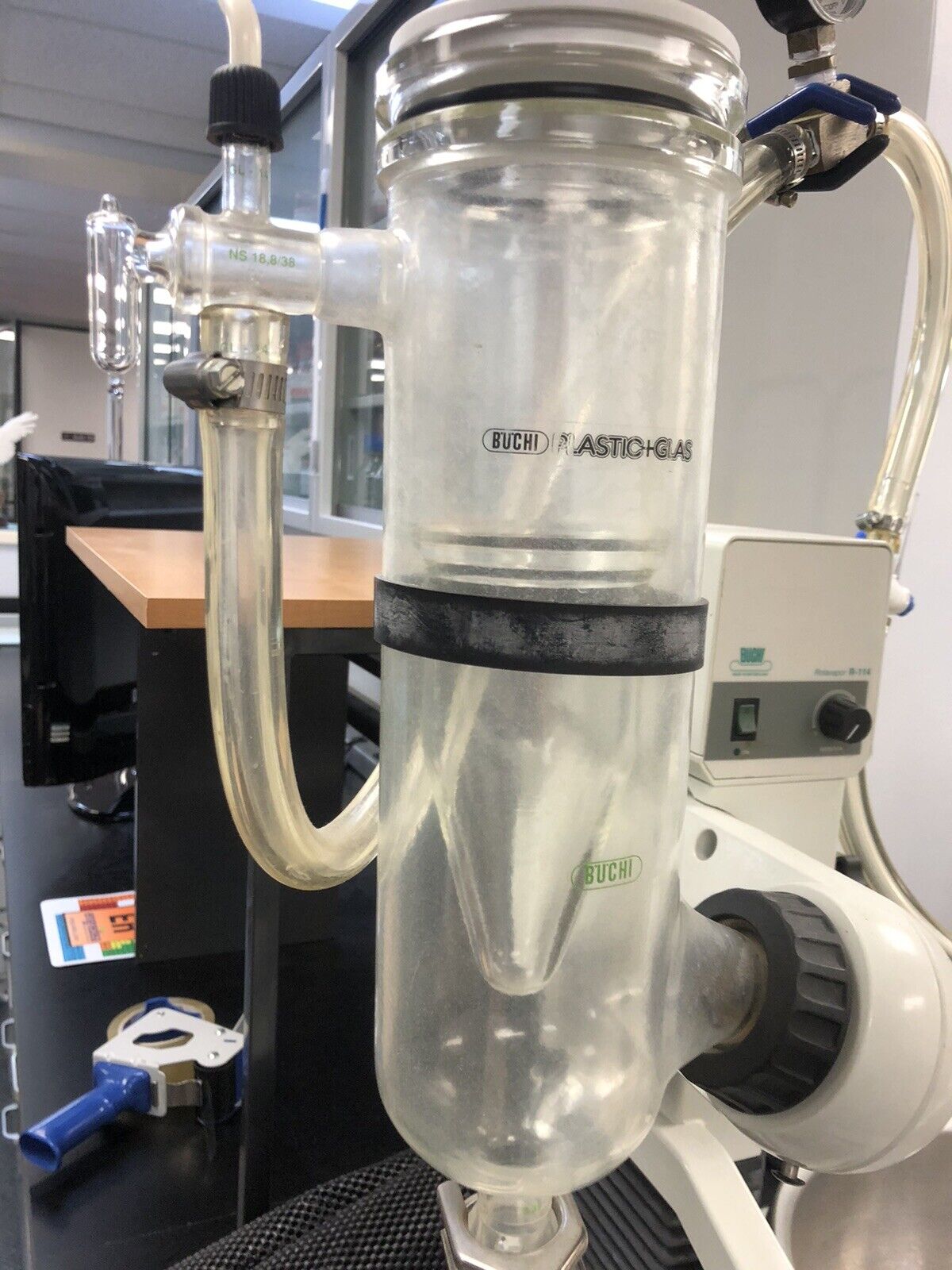 Transparent glass tube with black band and attached tubes.