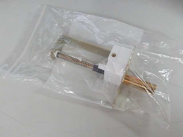 A small plastic bag with a metal object inside.