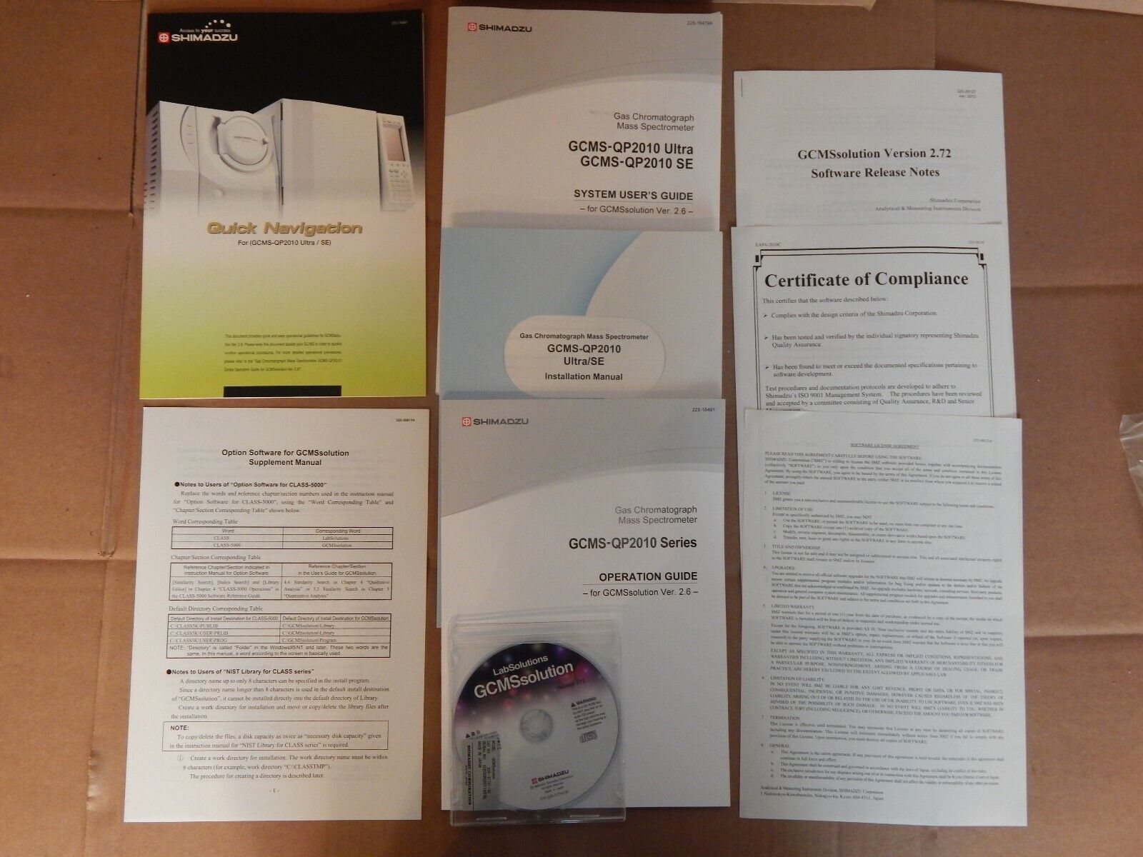 A picture of manuals and a CD for a Shimadzu GCMS-QP2010 Ultra.