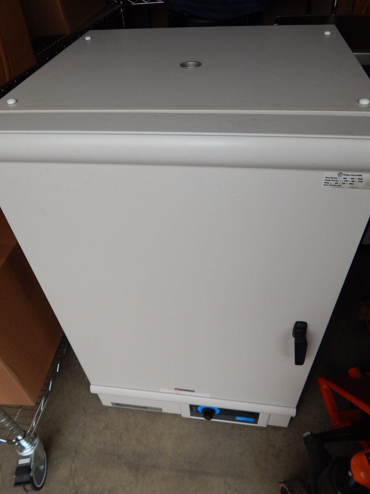 A large white oven with a black knob.