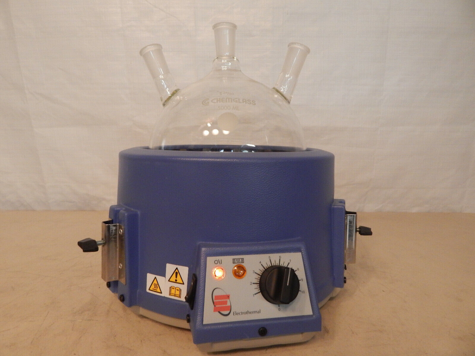 Blue round heating mantle with three necks.