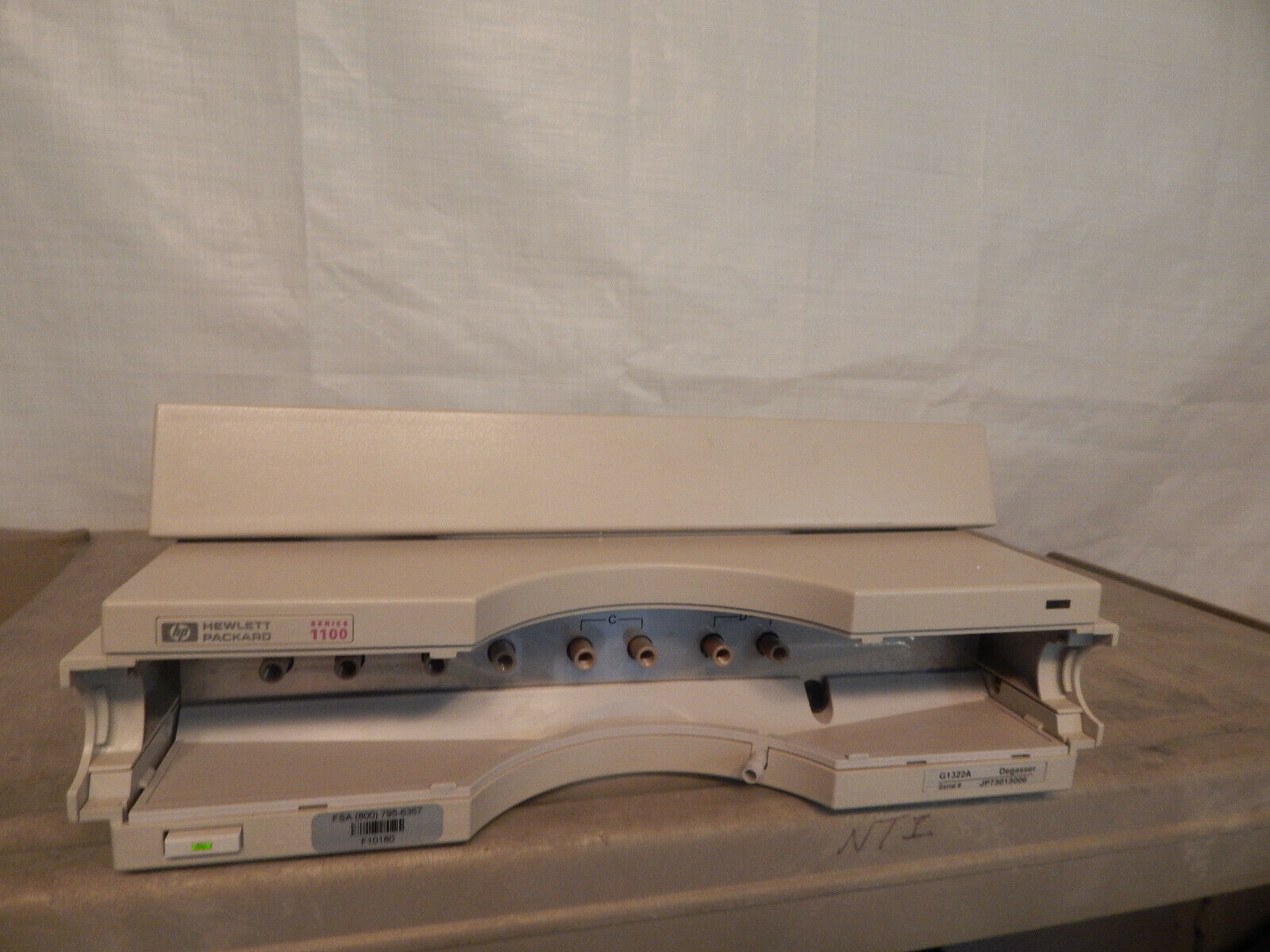 Opened beige Hewlett Packard 1100 printer.